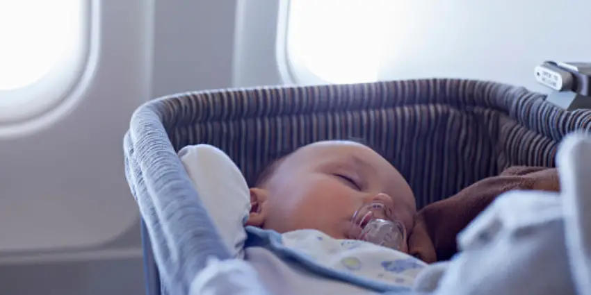 Travelling can be an adventure, especially when you have a baby in tow. From packing their essentials to making sure you've got everything under control, travelling with a little one requires a little extra thought and preparation. One of the many decisions that parents face when flying with their baby is choosing the perfect airplane seat. The eternal debate between window or aisle seat with baby comes down to personal preferences and your baby's unique needs. . In this comprehensive article, we'll examine the pros and cons of each option to help you make the best choice for your family. The Tale of Two Seats: Window vs. Aisle The Window Seat Pros The window seat is an appealing option for many reasons. For one, it provides a natural barrier between your baby and the rest of the passengers. This can be particularly helpful if your baby is easily distracted or tends to grab things. The window also acts as a built-in source of entertainment; your little one might be fascinated by the view outside, which can help keep them occupied during the flight. Another advantage of choosing the window seat with a baby is the extra privacy it provides, especially during feeding times. If you need to breastfeed, the window seat can give you a bit more seclusion than the aisle seat. Cons Despite the perks, the window seat also has its disadvantages. For instance, it can be more challenging to get in and out of the seat with a baby, especially if the passengers in the middle and aisle seats are asleep or watching movies. This could make diaper changes and restroom trips a bit more cumbersome. The Aisle Seat Pros The aisle seat is a popular choice for parents because of the easy access it provides. It makes getting up for diaper changes, restroom visits, and walking with a fussy baby much more convenient. Aisle seats also allow for quicker and smoother boarding and deplaning, which can be a blessing when you have a tired or restless baby. Another advantage of the aisle seat is the extra legroom it provides. While this may not be a significant factor for your baby, it can make a big difference to your comfort level during the flight. Cons The downside of the aisle seat is the lack of privacy and the increased likelihood of disturbances. With people walking by and the flight attendants serving food and drinks, it can be challenging to maintain a calm and quiet environment for your baby. Additionally, there's the risk of your baby's hands or legs being bumped by passengers or service carts. Additional Tips for Flying with a Baby Regardless of whether you choose a window or aisle seat, there are some additional tips to help ensure a smoother and more enjoyable flight with your baby: Timing is Everything Try to book your flight during your baby's usual nap or sleep time. This can increase the chances that your baby will sleep during the flight, making the journey more comfortable for everyone. Dress for Comfort Dress your baby in layers to accommodate varying temperatures on the plane. Opt for comfortable, soft clothes that allow for easy diaper changes and ensure your baby is warm and cozy throughout the flight. Bring a Baby Carrier A baby carrier can be a lifesaver when navigating airports and boarding the plane. It allows you to have your hands free while keeping your baby close and secure. Pack Entertainment and Comfort Items Bring a few familiar toys and comfort items, such as a favorite blanket or stuffed animal, to help your baby feel more at ease during the flight. Additionally, pack age-appropriate activities or toys to keep your baby entertained and engaged. Prepare for Ear Pressure Changes in cabin pressure can cause discomfort for babies, especially during takeoff and landing. To help alleviate this, offer your baby a pacifier, bottle, or breastfeed during these times to encourage swallowing, which can help equalize the pressure in their ears. Seek Assistance from Flight Attendants Don't hesitate to ask for help from flight attendants if you need assistance with your baby or have any questions. They are usually more than willing to help make your flight more comfortable and can provide useful tips and resources. Practice Patience and Flexibility Flying with a baby can be unpredictable, and even the best-laid plans can go awry. Be prepared to adapt to your baby's needs and remain patient and understanding. Remember that other passengers were once babies too, and most people will empathize with your situation. In the end, the choice between a window or aisle seat with a baby will depend on your individual needs and preferences. Consider the pros and cons of each option and make a decision that best suits your family's requirements. By following these additional tips and maintaining a positive attitude, you'll be well on your way to a successful and enjoyable flight experience with your little one. Extra Measures for a Stress-Free Flight While the choice between a window or aisle seat with a baby is crucial, there are additional measures you can take to ensure a stress-free and pleasant flight experience for you and your baby. Familiarize Yourself with Airline Policies Each airline has different policies regarding travelling with infants, such as fees, age restrictions, and baggage allowances. Familiarize yourself with these policies and make any necessary arrangements in advance to avoid surprises on the day of travel. Reserve Seats in Advance Whenever possible, reserve your seats in advance to ensure you get your desired seating arrangement, whether it's a window or aisle seat. This can also help you avoid the stress of not being seated together as a family on the plane. Pack Extra Supplies It's always better to be over-prepared when flying with a baby. Bring extra diapers, wipes, clothes, and snacks in case of delays or unexpected incidents. This will give you peace of mind and allow you to focus on enjoying the journey. Bring Documentation If your baby is travelling internationally or qualifies for a lap infant ticket, make sure you have all necessary documentation, such as passports, birth certificates, and vaccination records. Having these documents readily available will help expedite the check-in process and ensure a smooth travel experience. Choose Direct Flights When possible, choose direct flights to minimize layovers and the hassle of navigating multiple airports with a baby. Although direct flights might be more expensive, the convenience and reduced stress can be well worth the extra cost. Arrive Early Give yourself plenty of time to navigate the airport, check in, go through security, and board the plane. Arriving early can help reduce stress and allow you to handle any unexpected situations with more ease. Stay Hydrated and Well-rested Travelling can be exhausting, especially for new parents. Ensure you are well-rested before your flight and stay hydrated throughout the journey. Taking care of yourself will make it easier to care for your baby and handle any challenges that arise. Connect with Other Parents Don't be afraid to connect with other parents on the plane. They can offer support, advice, and understanding, making the flight more enjoyable and less isolating. By considering the advantages and disadvantages of window and aisle seats, preparing thoroughly, and implementing these additional measures, you'll be well-equipped to navigate the challenges of flying with a baby. With the right mindset and a well-thought-out plan, you can make your flight experience a memorable and enjoyable part of your family's travels. Creating a Positive In-flight Environment Beyond choosing between a window or aisle seat, ensuring a positive in-flight environment for your baby is essential for a pleasant flying experience. Here are some additional tips to help you create a comfortable atmosphere for your baby during your journey. Manage Cabin Noise Airplane cabins can be noisy, which may disturb your baby or make it difficult for them to sleep. Consider bringing noise-cancelling headphones or soft earplugs specifically designed for babies to help reduce the impact of the cabin noise. Use Comforting Routines Incorporate familiar routines from home to help your baby feel secure during the flight. For example, if you usually read them a bedtime story or sing a lullaby before sleep, continue to do so on the plane. This can help signal to your baby that it's time to rest and provide a sense of familiarity and comfort. Encourage Movement and Play When it's safe and allowed, encourage your baby to move around, stretch, and play, particularly if it's a long-haul flight. This can help keep them entertained and alleviate restlessness. Keep Calm and Reassure Your Baby Your baby can pick up on your emotions and stress, so try to remain calm and composed throughout the flight. If your baby becomes fussy or upset, reassure them with gentle touches, soothing words, and a calm demeanor. Be Prepared for Changes in Cabin Temperature Cabin temperatures can fluctuate during a flight, so it's essential to dress your baby in layers and bring a light blanket to ensure they stay comfortable throughout the journey. Being prepared for temperature changes will help your baby stay cozy and content. Seek Out Family-friendly Airports and Airlines When planning your trip, consider choosing airlines and airports that offer family-friendly amenities and services, such as dedicated family lanes at security, complimentary strollers, or play areas for children. These services can make your travel experience more enjoyable and stress-free. Communicate with Fellow Passengers A little communication goes a long way in creating a positive in-flight environment. If you sense that your baby's fussiness is bothering nearby passengers, acknowledge the situation and apologize if necessary. Most people will appreciate your understanding and may even offer support or assistance. By implementing these tips and strategies, you can create a positive in-flight environment for your baby and ensure a more enjoyable flying experience for your entire family. Remember that flexibility, preparation, and a positive attitude are key to successfully navigating the challenges of flying with a baby, whether you choose a window or aisle seat. Frequently Asked Questions (FAQs) Where is the best place to sit on a plane with a baby? The best place to sit on a plane with a baby depends on your preferences and your baby's needs. If privacy and a natural barrier are essential to you, a window seat might be the best choice. On the other hand, if easy access and additional legroom are your priorities, the aisle seat could be a better option. Is the window seat safer than the aisle seat? There is no significant difference in safety between the window and aisle seats. The most important factor in ensuring your baby's safety on a flight is to follow the airline's guidelines and use an appropriate child restraint system when required. Should I fly with an infant on my lap or in a separate seat? The decision to fly with an infant on your lap or in a separate seat depends on your preferences, budget, and the child's age. While it is generally more affordable to fly with a baby on your lap, purchasing a separate seat and using an approved child restraint system can provide additional safety and comfort for your baby. What is the hardest age to fly with a baby? The hardest age to fly with a baby can vary depending on the child's temperament and development. However, many parents find that the toddler stage (between 1 and 3 years old) can be particularly challenging due to increased mobility, curiosity, and potential for tantrums. At this age, children may have difficulty staying seated and may not fully understand the concept of waiting or being quiet for extended periods. What is the disadvantage of an aisle seat? The main disadvantage of an aisle seat is the lack of privacy and the increased likelihood of disturbances. With passengers walking by and flight attendants serving food and drinks, it can be more difficult to maintain a calm and quiet environment for your baby. Additionally, there is the risk of your baby's hands, legs, or belongings being bumped by people passing by or service carts. What is the disadvantage of a window seat? The primary disadvantage of a window seat is the limited access to the aisle, which can make getting in and out of the seat more challenging. This can be particularly inconvenient when travelling with a baby, as it may require frequent trips to the restroom for diaper changes, soothing a fussy baby, or simply needing to stretch your legs. What is the safest seat for a baby seat? The safest seat for a baby seat depends on the specific aircraft and airline guidelines. In general, the safest place for a baby seat is in a rear-facing position and away from any potential impact zones, such as the bulkhead. It is essential to follow the airline's guidelines and use an approved child restraint system when required. Making the Decision: Window or Aisle Seat with Baby In conclusion, the choice between a window or aisle seat with a baby comes down to personal preferences and your baby's unique needs. While the window seat offers more privacy and a natural barrier, the aisle seat provides easier access and additional legroom. It's essential to weigh the pros and cons of each option and consider factors such as your baby's age, temperament, and the flight's duration when making your decision. Remember that no matter which seat you choose, the key to a successful flight with a baby lies in preparation and flexibility. Make sure to pack all necessary items, such as snacks, toys, and a change of clothes, and be prepared to adapt to your baby's needs throughout the flight. With some planning and patience, you can make flying with a baby a smooth and enjoyable experience for both you and your little one.